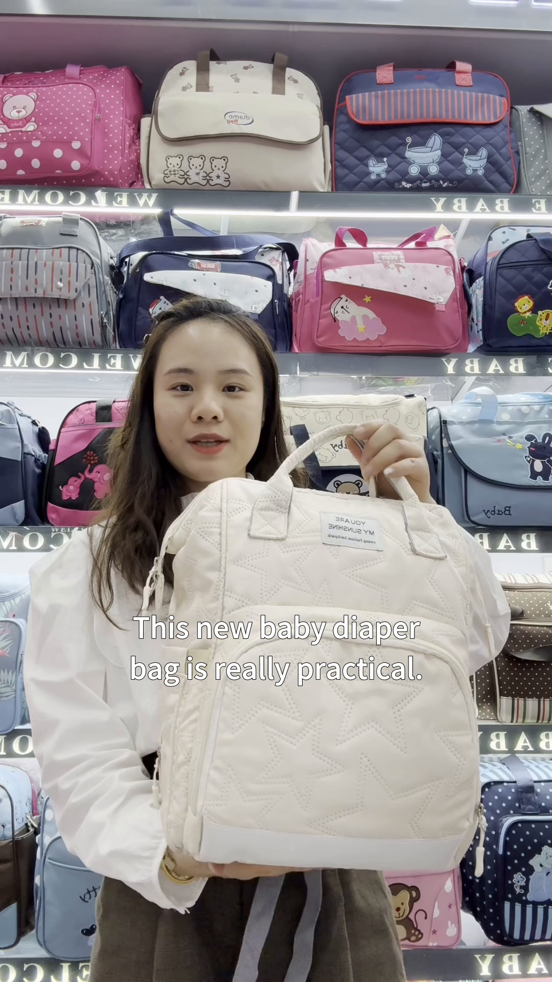 Practical diaper bag with stylish embroidery keeps baby warm and items organized